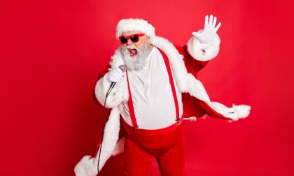 Portrait of cool funny fat overweight santa claus with big belly sing song on christmas party wear style stylish trendy eyeglasses eyewear, hat isolated over red background