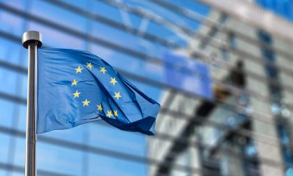 European Union flags in front of the blurred European Parliament in Brussels, Belgium
