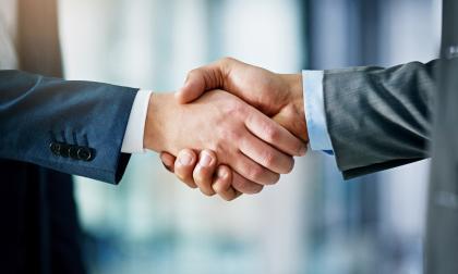 Closeup shot of two businessmen shaking hands in an office