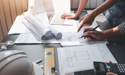 Architect man engineer construction concept using blueprints at the office.