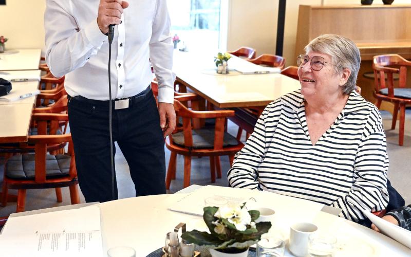 Per Nyberg underhåller med sång och även med olika skämt. Maj-Gret Wikstrand lyssnar.